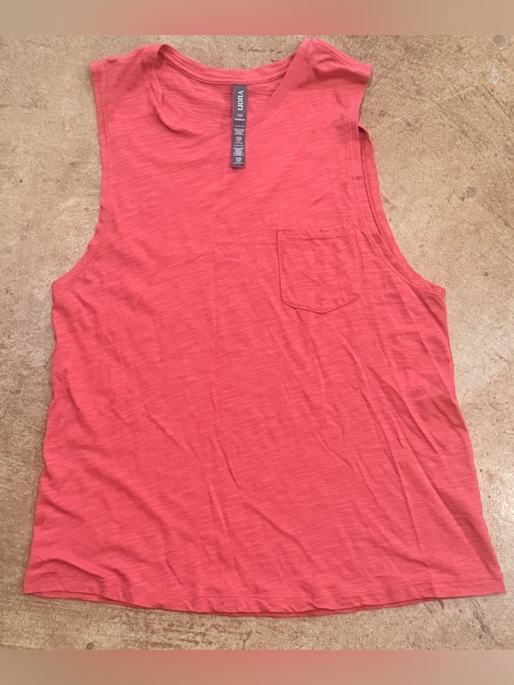 Vuori Sunset Tank in a coral-pink colorway medium